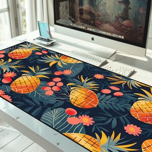 May include: A tropical-themed mousepad with a dark blue background, featuring a repeating pattern of pineapples, red berries, and green leaves.