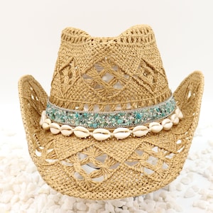 May include: A straw cowboy hat with a turquoise and silver beaded band and white shell accents.
