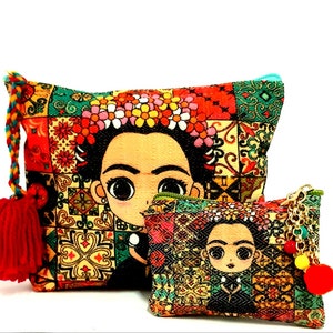 May include: Two colorful fabric pouches with a Frida Kahlo inspired design. The larger pouch has a red tassel and the smaller pouch has a gold chain and a yellow pom-pom.