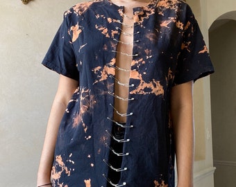 acid wash tee with chains and safety pins down the middle