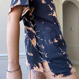 acid wash tee with chains and safety pins on the sides