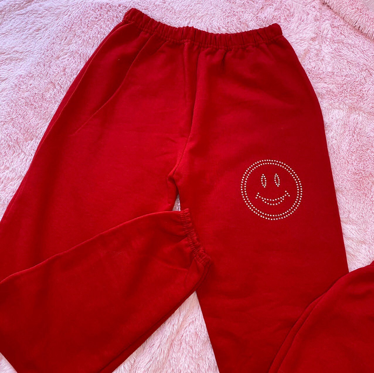 Handmade red sweatpants with a clear rhinestone smiley face | Etsy
