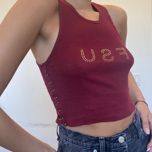 handmade burgundy top with safety pins and “FSU” in rhinestone letters