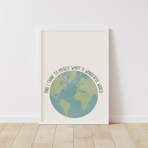May include: A white framed print with a blue and green globe illustration and the text "And I think to myself what a wonderful world".