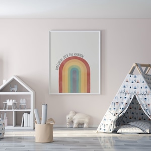 May include: A white framed print with a rainbow and the text "Somewhere over the rainbow" in a children's playroom with a white teepee tent and a white elephant figurine.