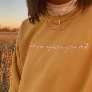 love your neighbor embroidered crewneck sweatshirt | love knows no race | mustard | black | sandstone | green |