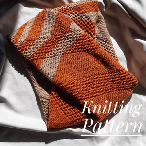 May include: A knitted scarf in orange and beige with a textured stitch pattern. The scarf is folded in half and the text "Knitting Pattern" is written below it.