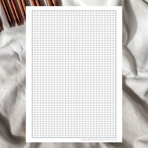 Könnte beinhalten: Ein leeres weißes Blatt Papier mit einem gedruckten Rastermuster. Das Raster besteht aus kleinen, gleichmäßig verteilten Quadraten.