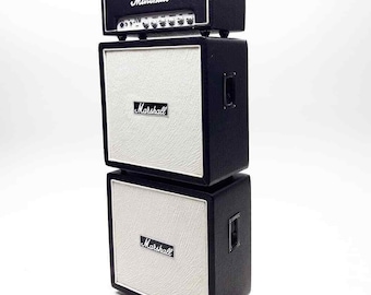 May include: A stack of three black Marshall guitar amplifiers. The top amplifier is smaller than the two below it. All three amplifiers have a white speaker grill and a black Marshall logo.