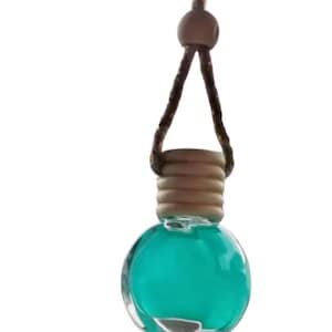 May include: A teal blue glass car air freshener with a wooden cap and a brown string for hanging.