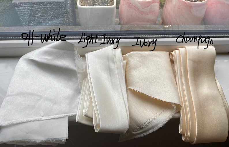 May include: Four fabric swatches in different shades of white, labeled "off-white", "light ivory", "ivory", and "champagne".
