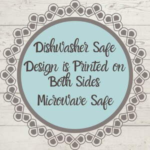 May include: A circular graphic with a light blue center and a dark gray decorative border. The text reads: DishWasher Safe, Design is Printed on Both Sides, Microwave Safe. The lettering is in a dark gray, cursive-style font.