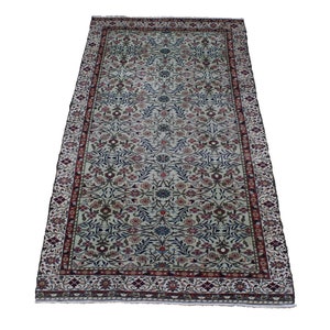 May include: A cream-colored rug with a floral pattern in shades of red, blue, and green. The rug has a border with a repeating pattern of flowers and leaves.
