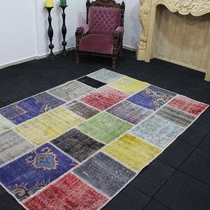 May include: A colorful patchwork rug with a variety of colors and patterns, including blue, green, yellow, red, and brown. The rug is made of different pieces of fabric that have been sewn together.