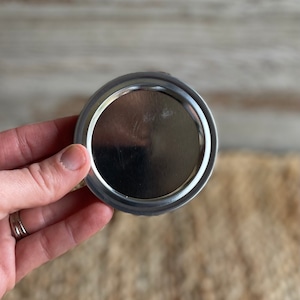 May include: Silver metal lid for a jar or can.