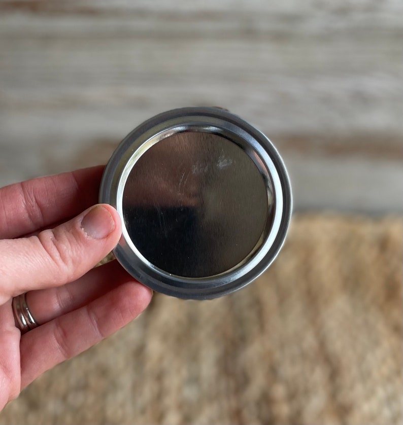 May include: Silver metal lid for a jar or can.