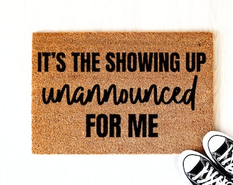 May include: A brown coir doormat with the text "It's the showing up unannounced for me" in black lettering.