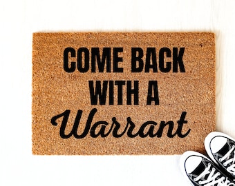 May include: A brown coir doormat with the text "Come Back With A Warrant" in black lettering.