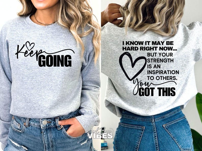 May include: Gray sweatshirt with black text that reads "Keep Going" on the front and "I know it may be hard right now... But your strength is an inspiration to others. You got this" on the back.