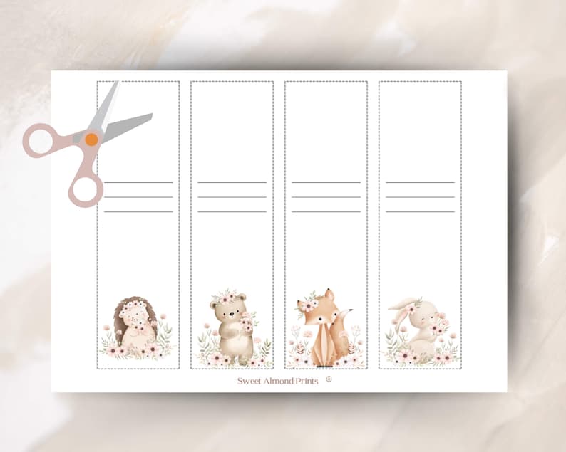 May include: A sheet of printable bookmarks featuring watercolor illustrations of woodland animals: a hedgehog, bear, fox, and bunny, each adorned with floral crowns. The design includes dotted lines for cutting and horizontal lines for writing. A pair of scissors is in the upper left corner.