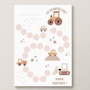 May include: A printable chart with a pink and brown color scheme featuring a construction vehicle theme. The chart has a path of pink circles with stars and construction vehicles. The text on the chart reads "Du schaffst das!" and "Hurra. Geschafft!"