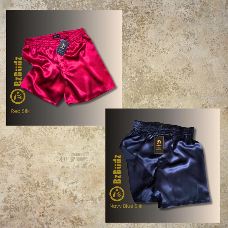 May include: Two pairs of satin shorts, one red and one navy blue. The shorts have an elastic waistband and a drawstring. The brand name "BzBuzz" is printed on the side of the shorts.
