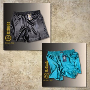 May include: Two pairs of satin shorts, one black and one teal green. The shorts have an elastic waistband and a drawstring. The brand name "BzBuddz" is printed on the shorts.
