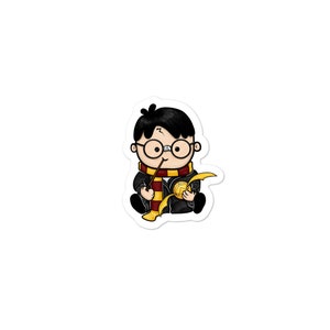 May include: A cartoon illustration of Harry Potter as a young boy wearing a black robe, a red and gold scarf, and round glasses. He is holding a wand and a golden snitch.