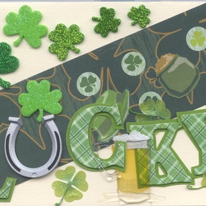May include: A green and white card with the word "LUCKY" spelled out in green and white plaid letters. The card is decorated with shamrocks, a horseshoe, and a glass of beer.