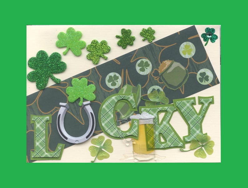 May include: A green and white card with the word "LUCKY" in large letters. The letters are decorated with a plaid pattern. The card is decorated with shamrocks, a horseshoe, and a beer mug.
