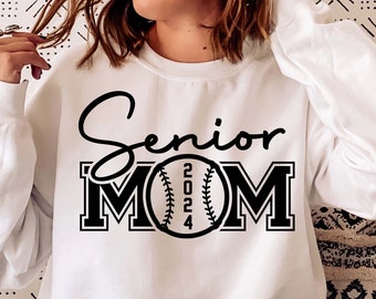 May include: White sweatshirt with black text that reads "Senior Mom" and a baseball with the year 2024 printed on it.