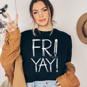 May include: A black t-shirt with white text that says "FRI-YAY!" with a pencil graphic. The text is in a handwritten style.