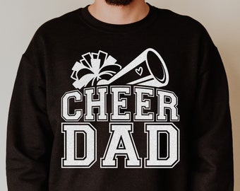 May include: Black sweatshirt with a white graphic of a cheerleader's pom pom and megaphone with the text "CHEER DAD" in white.