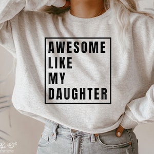 May include: Gray sweatshirt with a black square graphic that says "Awesome Like My Daughter".