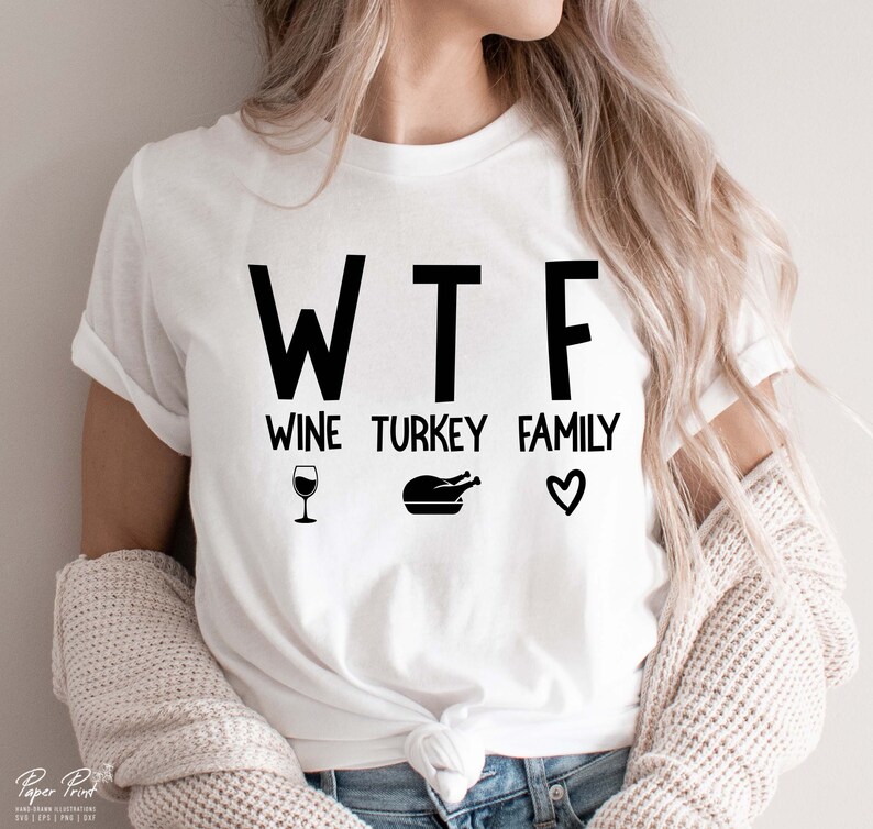 May include: White t-shirt with black text that reads "WTF Wine Turkey Family" with a wine glass, a turkey, and a heart graphic.