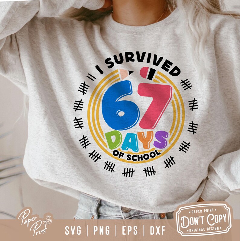 May include: A light gray sweatshirt with a colorful graphic that reads "I Survived 67 Days of School." The design includes a blue number 6, a pink number 7, and the word "DAYS" in green, orange, and purple. The design is surrounded by tally marks.