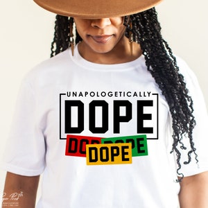 May include: White t-shirt with the text "Unapologetically Dope" in black lettering. The word "Dope" is repeated three times in smaller boxes with red, green, and yellow backgrounds.