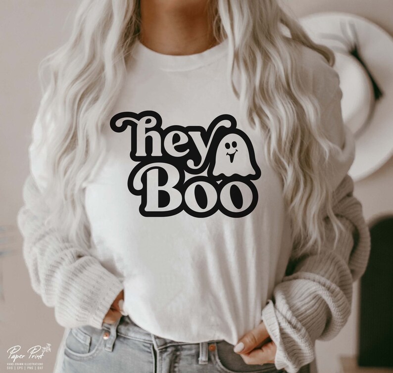 May include: White t-shirt with a black graphic that says "Hey Boo" with a ghost with a smiling face.