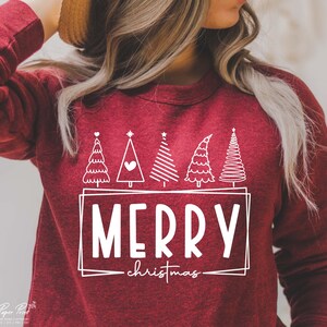May include: Red sweatshirt with a white design of five stylized Christmas trees and the text "Merry Christmas".