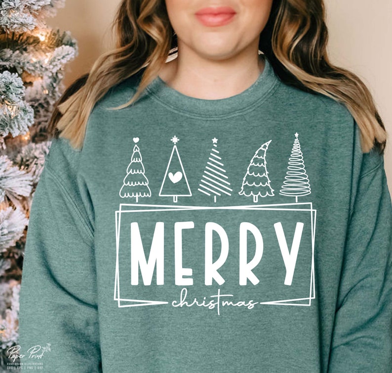 May include: A teal green sweatshirt with a white design of five stylized Christmas trees and the text "Merry Christmas" in a white box.