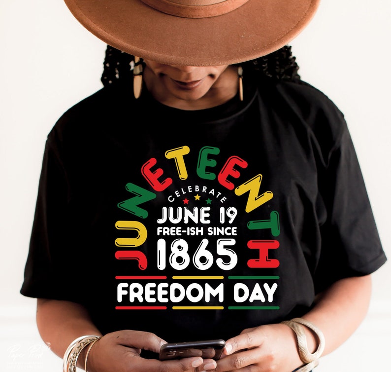 May include: A black t-shirt with a colorful graphic design that says "Juneteenth Celebrate June 19 Free-ish Since 1865 Freedom Day".