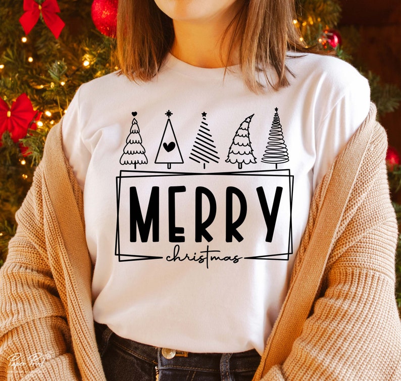May include: White t-shirt with a black and white graphic of Christmas trees and the text "Merry Christmas".