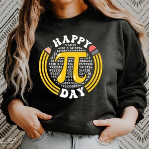 May include: Black sweatshirt with a yellow circle design featuring the mathematical constant pi and the text "HAPPY PI DAY".