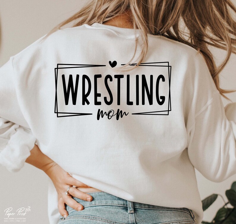 May include: White sweatshirt with black text that reads "Wrestling Mom" inside a black frame with a small heart above the text.