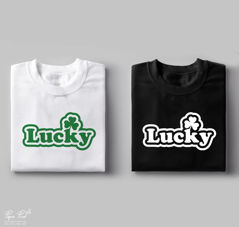 May include: Two t-shirts, one white and one black, with the word "Lucky" in a retro font and a green four-leaf clover graphic.