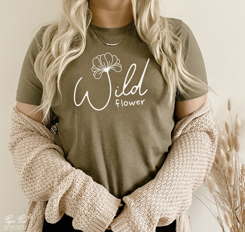 May include: A green t-shirt with a white graphic of a flower and the text "Wild flower".
