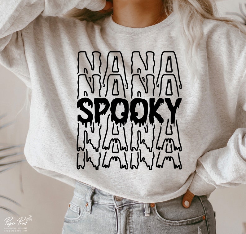 May include: A gray sweatshirt with a black graphic that says "NANA SPOOKY NANA" in dripping letters.