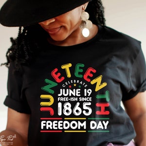 May include: A black t-shirt with a colorful graphic design that says "Juneteenth Celebrate June 19 Free-ish Since 1865 Freedom Day".