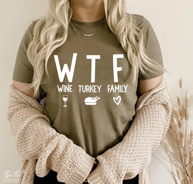 May include: A green t-shirt with the text "WTF" and the words "Wine, Turkey, Family" underneath. The words are in white and there are icons of a wine glass, a turkey, and a heart.