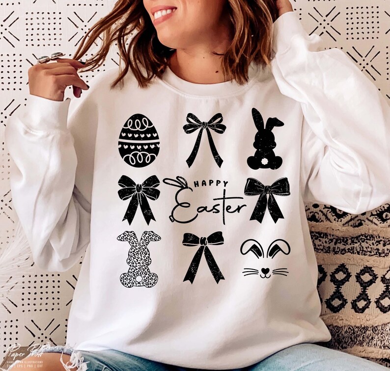 May include: White sweatshirt with a black graphic design featuring a bunny, bows, an egg, and the text "Happy Easter".